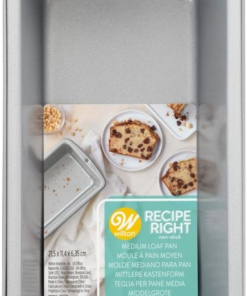 Retail-packaged Wilton Recipe Right medium loaf pan with label and baked goods on packaging.